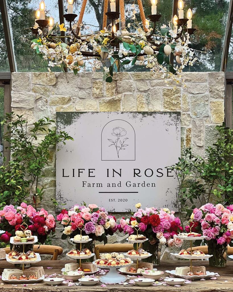 Guests at Life in Rose Farm are invited to take tea at a rustic table bedecked in a glorious selection of delectable fare and stunning flowers.
