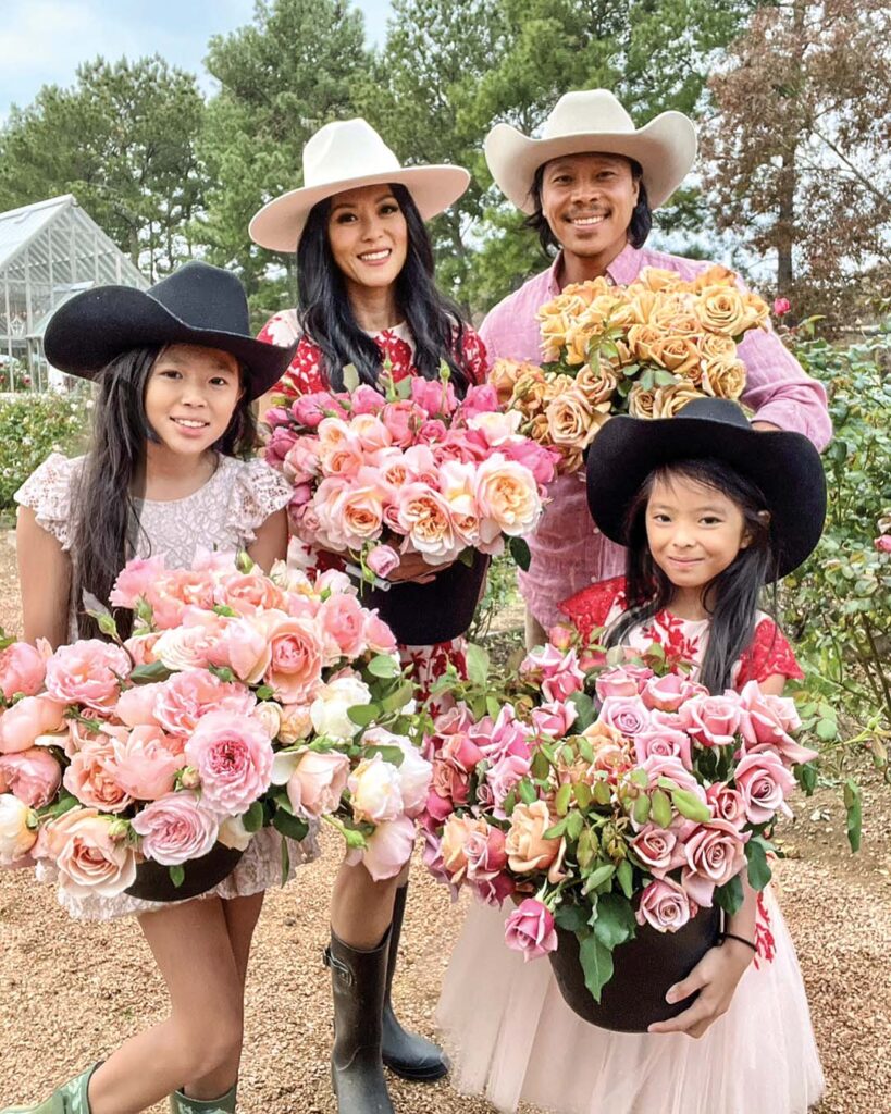 Theresa Pham, her husband Shaw Nguyen, and their two daughters, Loghan, front left, and Ava, front right, show off armfuls of their beautiful fresh blooms.