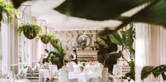 Servers prepare for afternoon tea in the lounge, veranda, and terrace of Cape Town’s Mount Nelson Hotel.
