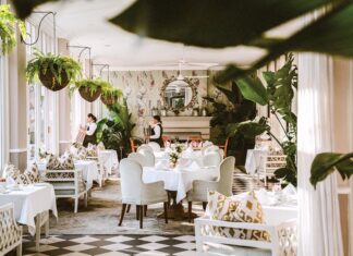 Servers prepare for afternoon tea in the lounge, veranda, and terrace of Cape Town’s Mount Nelson Hotel.