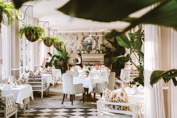 Servers prepare for afternoon tea in the lounge, veranda, and terrace of Cape Town’s Mount Nelson Hotel.