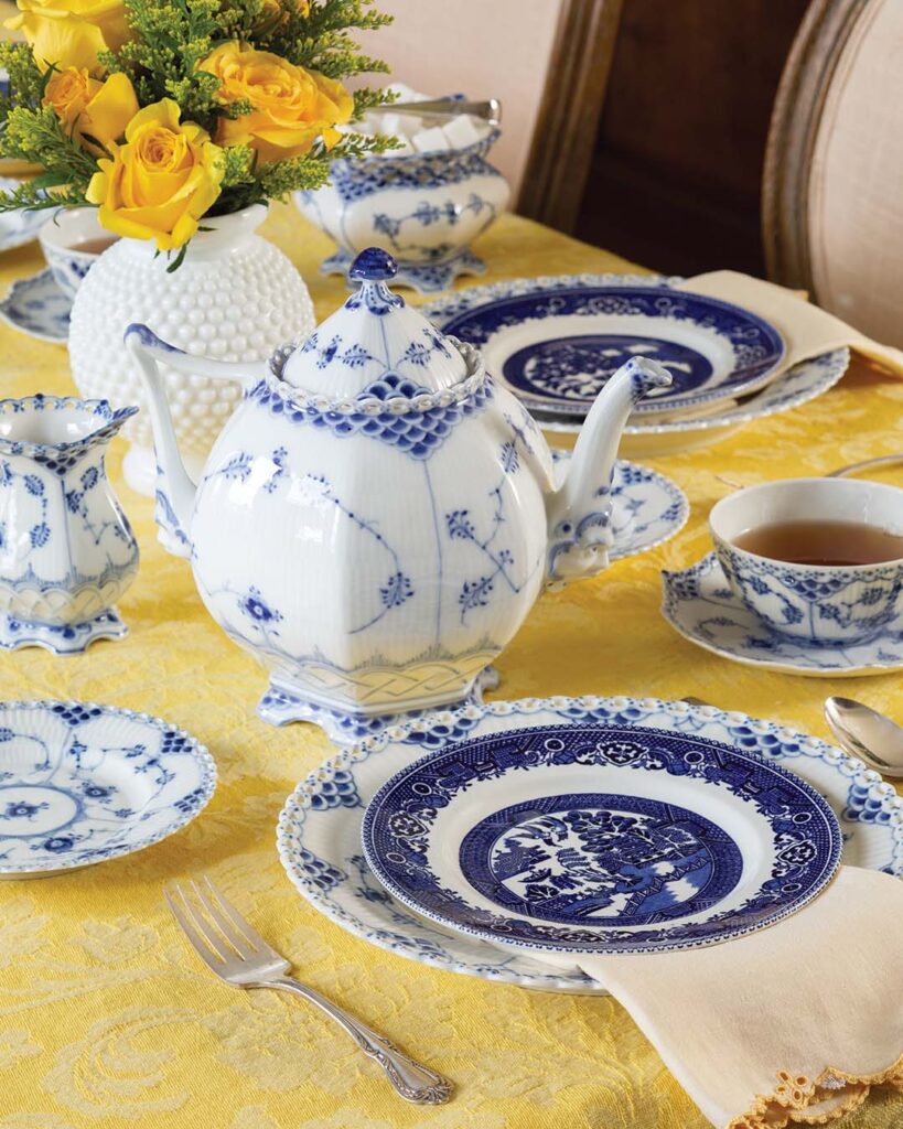 Royal Copenhagen’s Blue Fluted Full Lace teapot, luncheon plates, bread and butter plates, teacups, and creamer and sugar set are wonderfully matched with Alfred Meakin’s Old Willow dessert plates in a comparable hue. Incorporate shine with Oneida’s Wm. A. Rogers Chalice-Harmony flatware and bring brightness to the setting with April Cornell’s Garden Jacquard tablecloth.