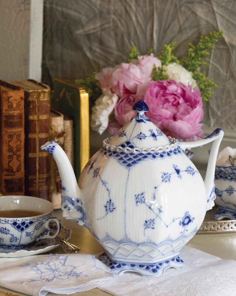 Royal Copenhagen Blue Fluted Full Lace teapot, flat teacup and saucer set, and open sugar bowl from Replacements, Ltd. Rogers Bros. First Love teaspoon available for rent at Tea and Old Roses. Antique silver tray and table linens from private collection.
