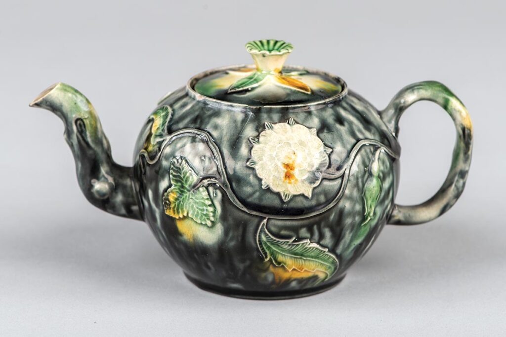 Circa 1750s earthenware teapot with applied leaves and flowers, probably from Staffordshire.