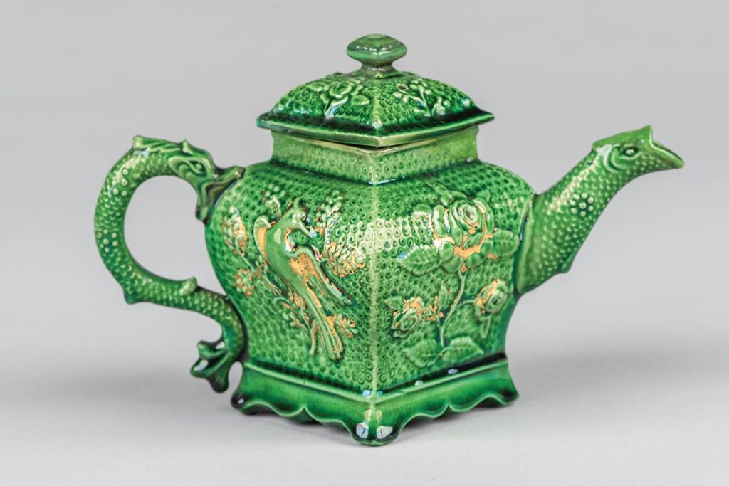Earthenware teapot with moulded and gilded decoration, probably made in Staffordshire.