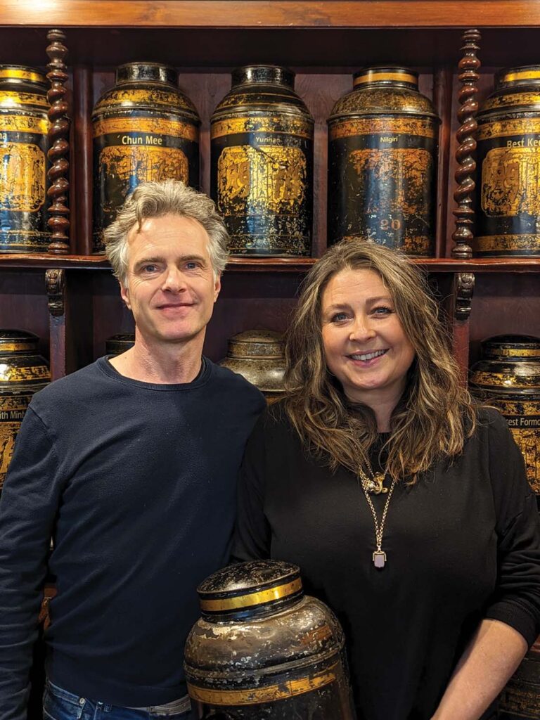 Scott Lakin, left, and his wife, Nikki, right, work in their Guildhall Market booth where treasured tins hold loose-leaf tea, which he blends by hand.