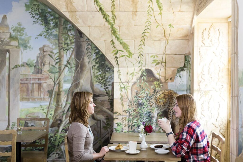 The painted walls of the Visitors’ Tearoom give the impression of enjoying a picnic in the ruins of an ancient temple.
