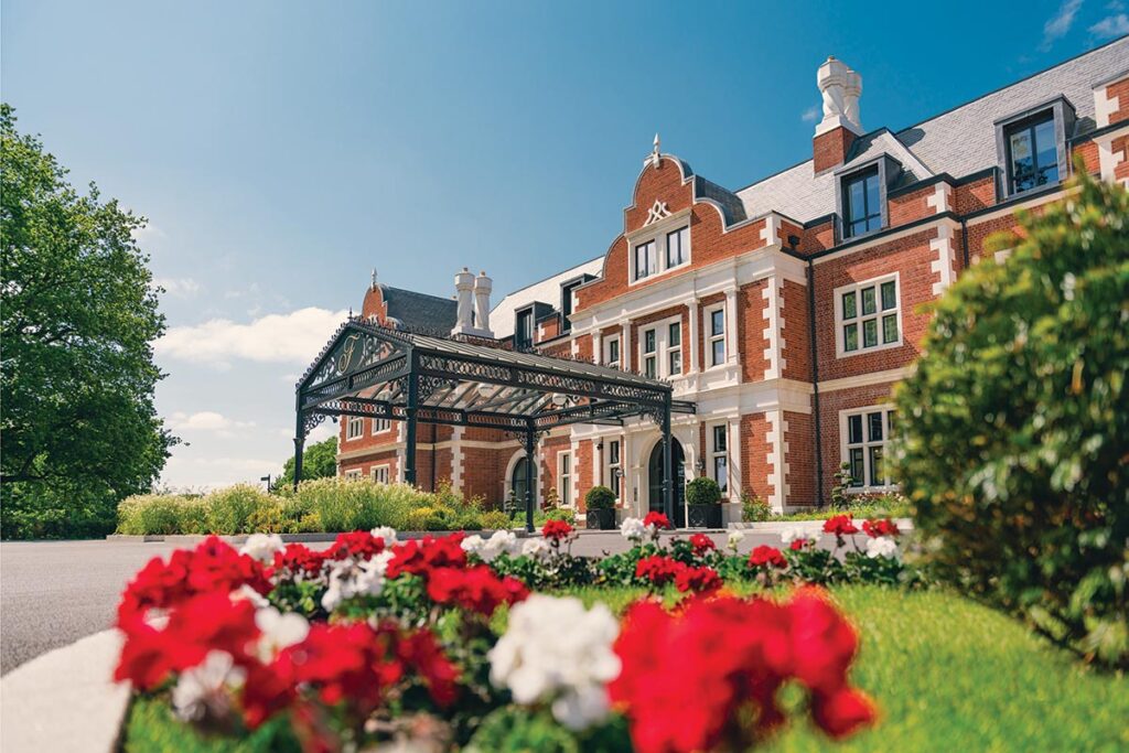 The main entrance for the hotel features chimneys and other architectural features reminiscent of Tudor buildings. Photograph Courtesy of Fairmont Windsor Park