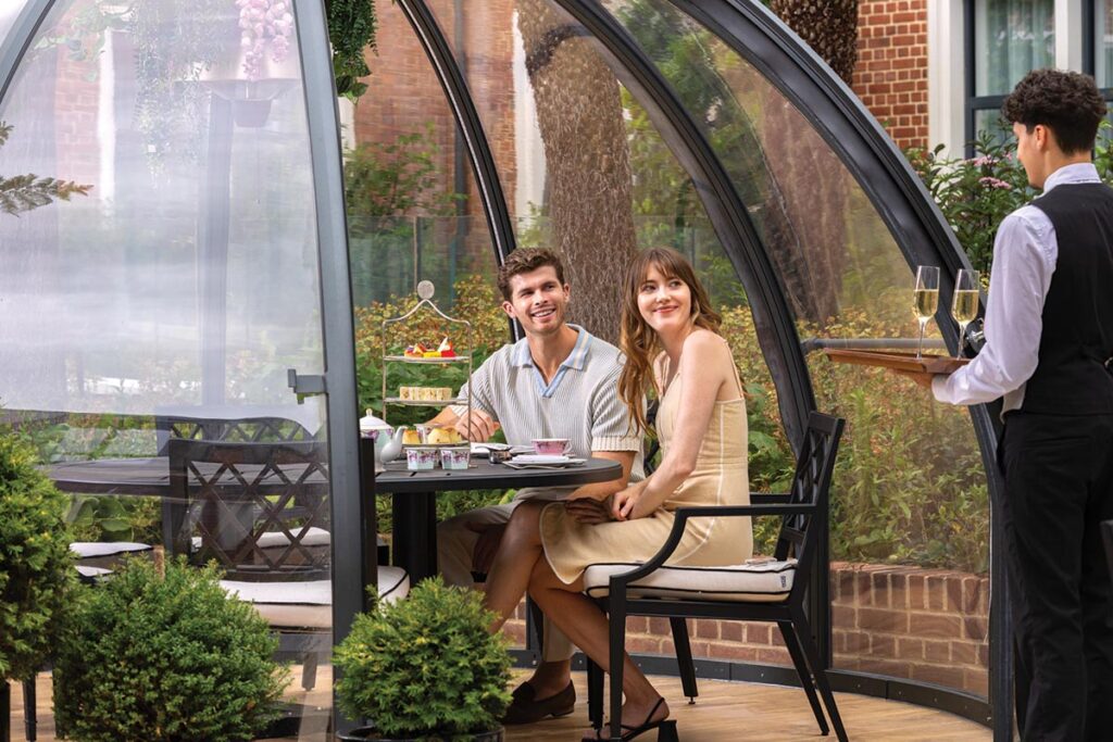 Afternoon tea can be enjoyed in one of the glass pods in the hotel garden. Photograph Courtesy of Fairmont Windsor Park