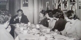 Vida and other young ladies excitedly enjoy afternoon tea with English actor Roger Moore at Elstree Studios.