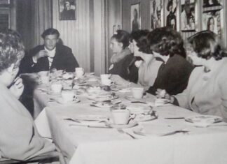 Vida and other young ladies excitedly enjoy afternoon tea with English actor Roger Moore at Elstree Studios.