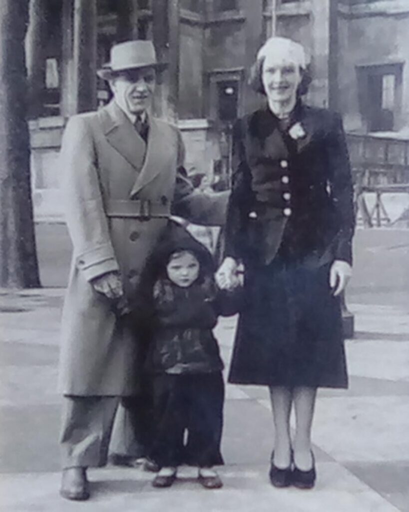 Vida Bickford stands between her mother and father as a young girl in London, England.
