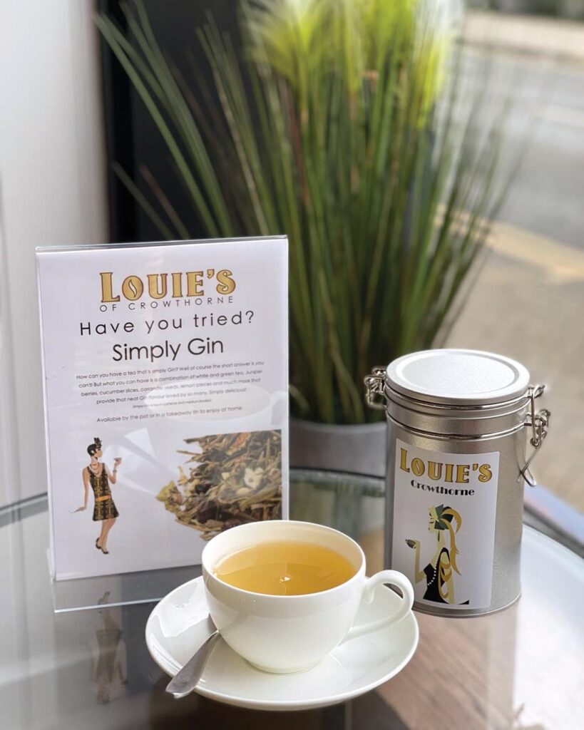 The artworks on the walls, the menu, and the tins of tea have a jazz-age feel to them and add an attractive sophistication to the room. Photograph Courtesy of Louie’s Coffee & Teahouse