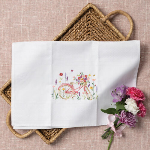 Tea towel with pink bicycle embroidery