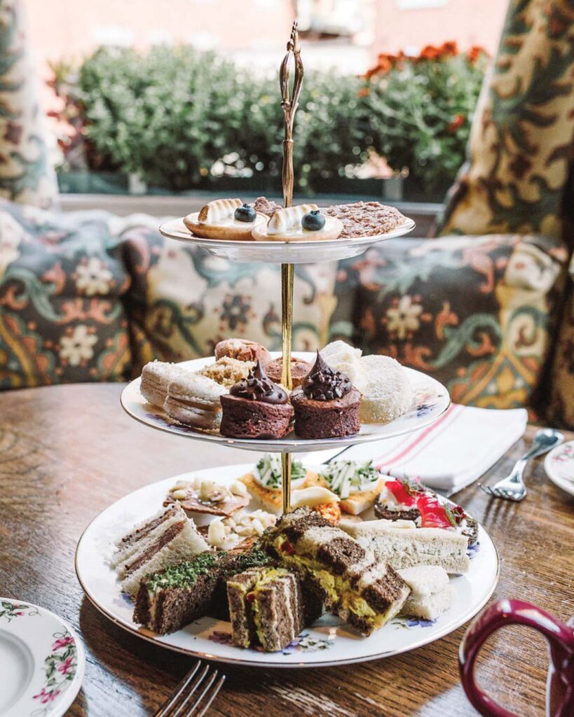 A tiered stand brims with tea fare.